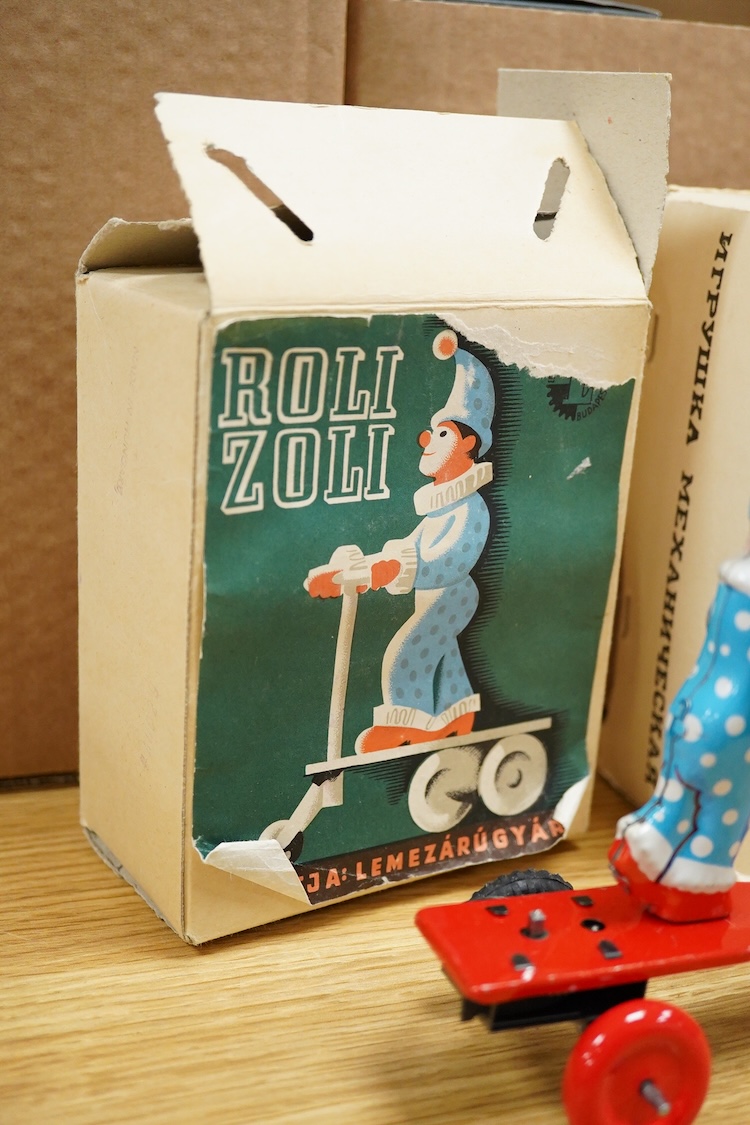Three boxed clockwork tinplate toys - a 1960s Japanese Cubby the Reading Bear, by Alps (Japan), 17cm high, a USSR doll, and a later ‘Roli Zoli’ clown on a scooter (3)